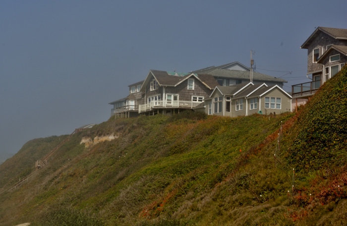 house on cliff overlooking beach